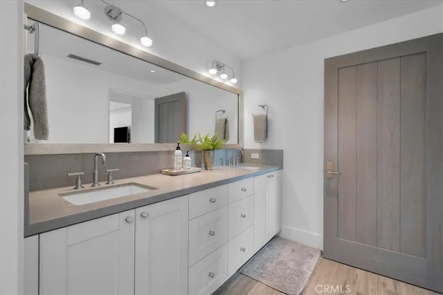 a spacious bedroom with a bed a couch and a flat screen tv