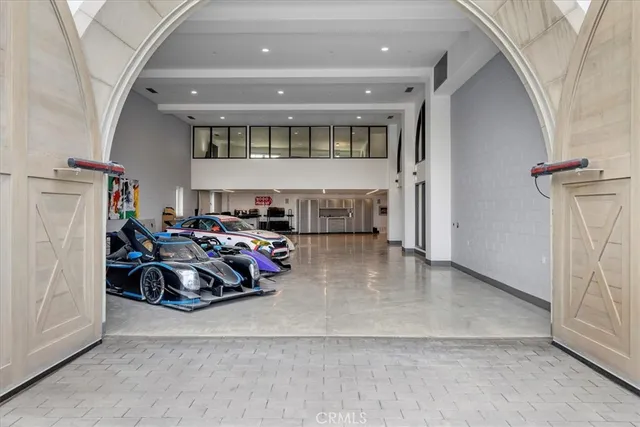 a kitchen with stainless steel appliances a table and chairs in it