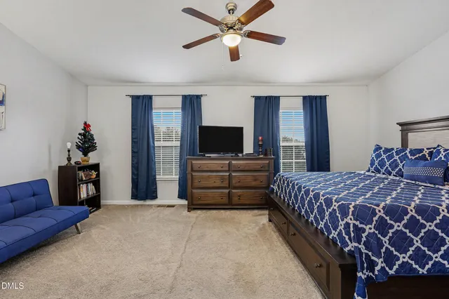 a bedroom with a bed and a couch