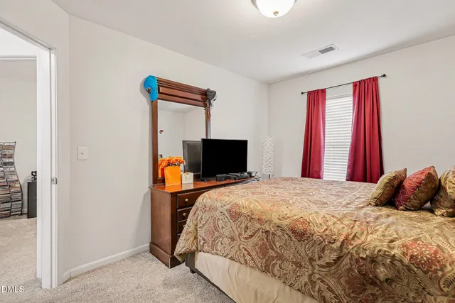 a bedroom with a bed and a television