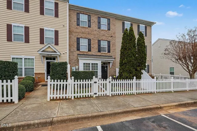 a front view of a house with iron fence