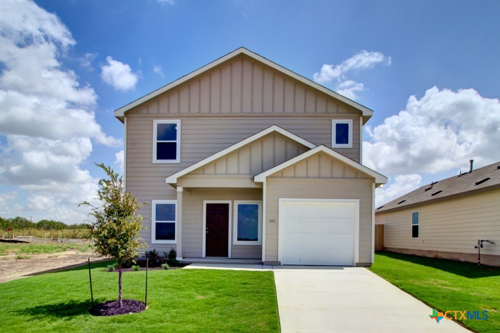 11242 Prairie Landing Converse, TX 78109 - Photo 1 of 24 a front view of a house with a yard and garage