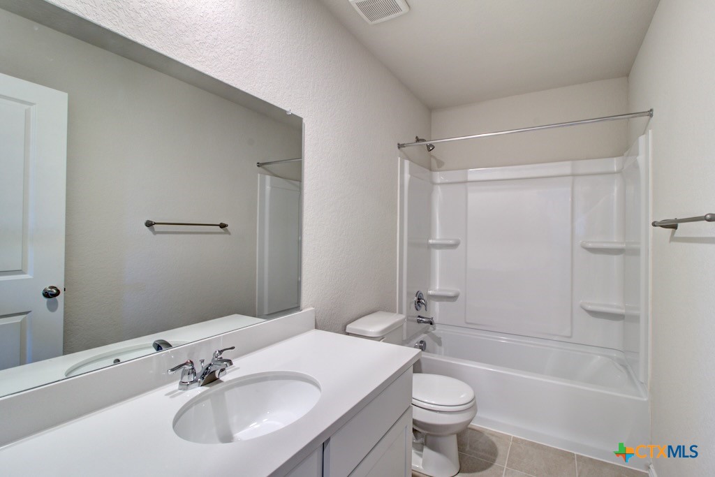 11242 Prairie Landing Converse, TX 78109 - Photo 20 of 24 a bathroom with a sink a toilet and shower