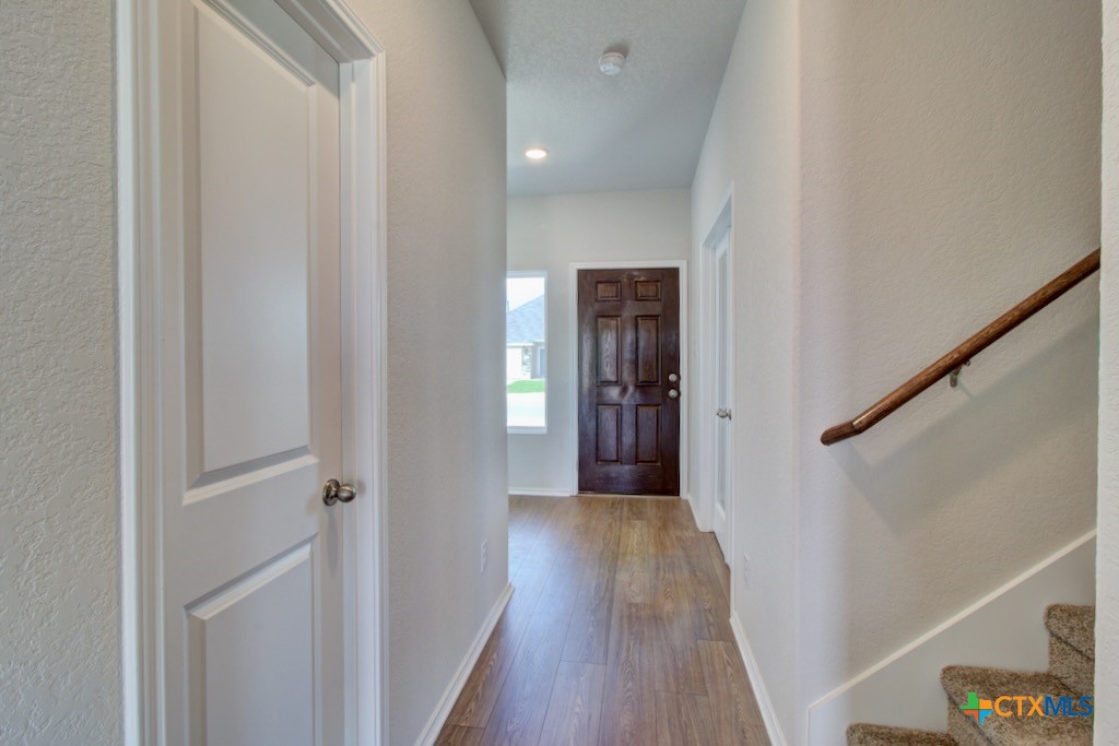 11242 Prairie Landing Converse, TX 78109 - Photo 2 of 24 a view of a hallway with wooden floor