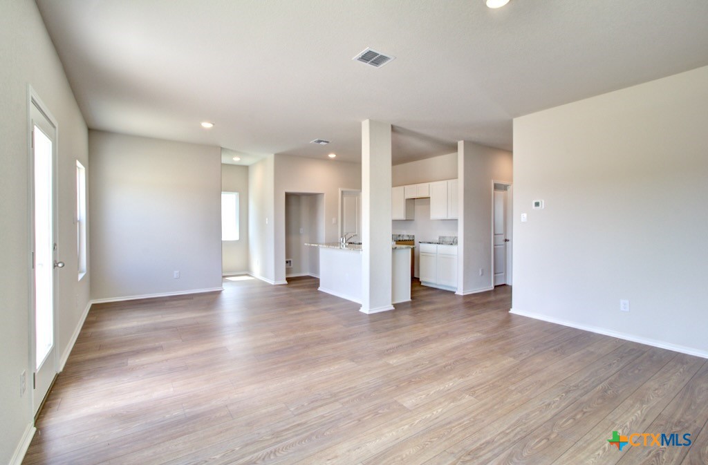 11242 Prairie Landing Converse, TX 78109 - Photo 7 of 24 a view of a kitchen with a refrigerator and a sink
