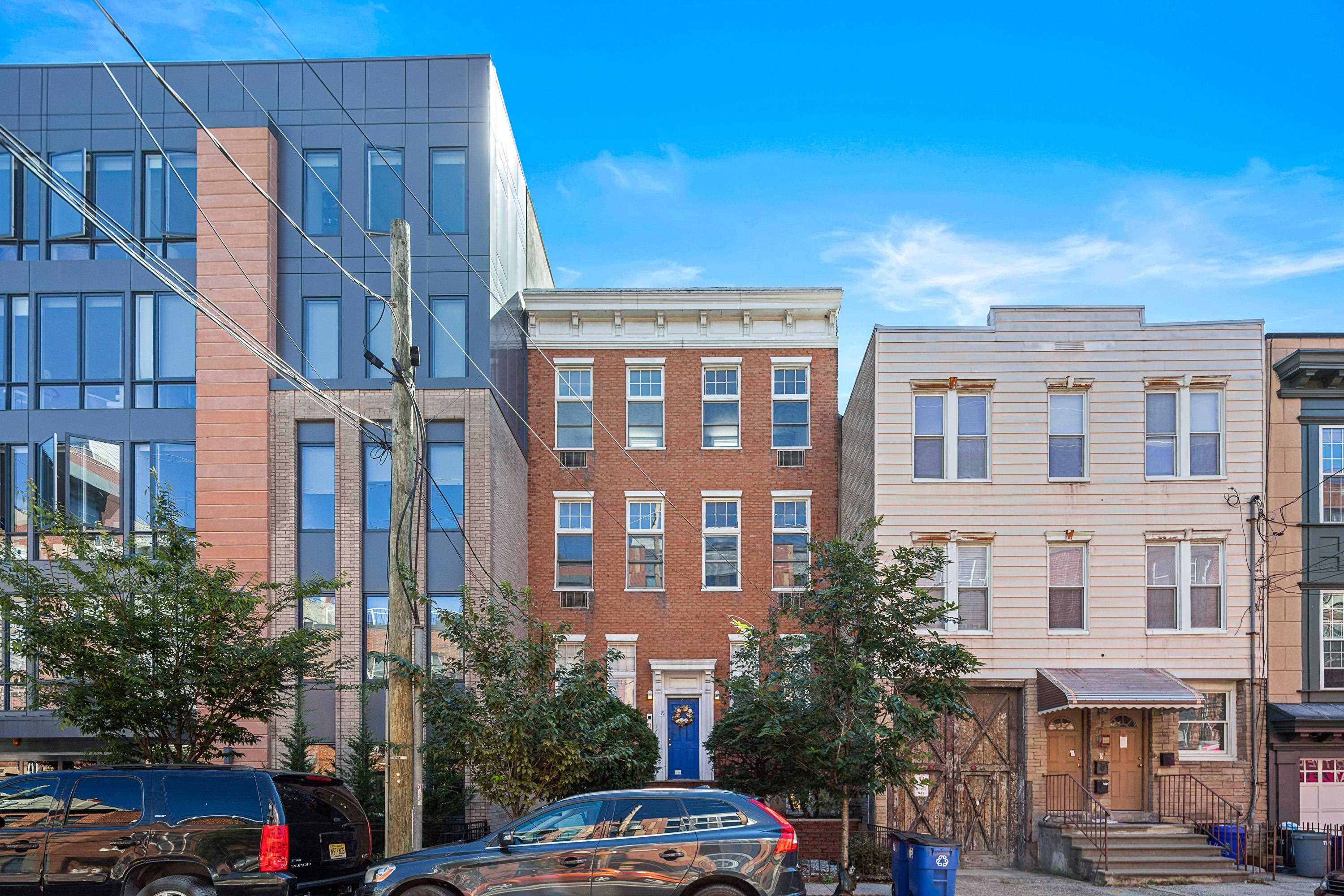 73 Madison Street, Unit 1N Hoboken, NJ 07030 - Photo 1 of 17 a front view of a building with lot of cars and trees