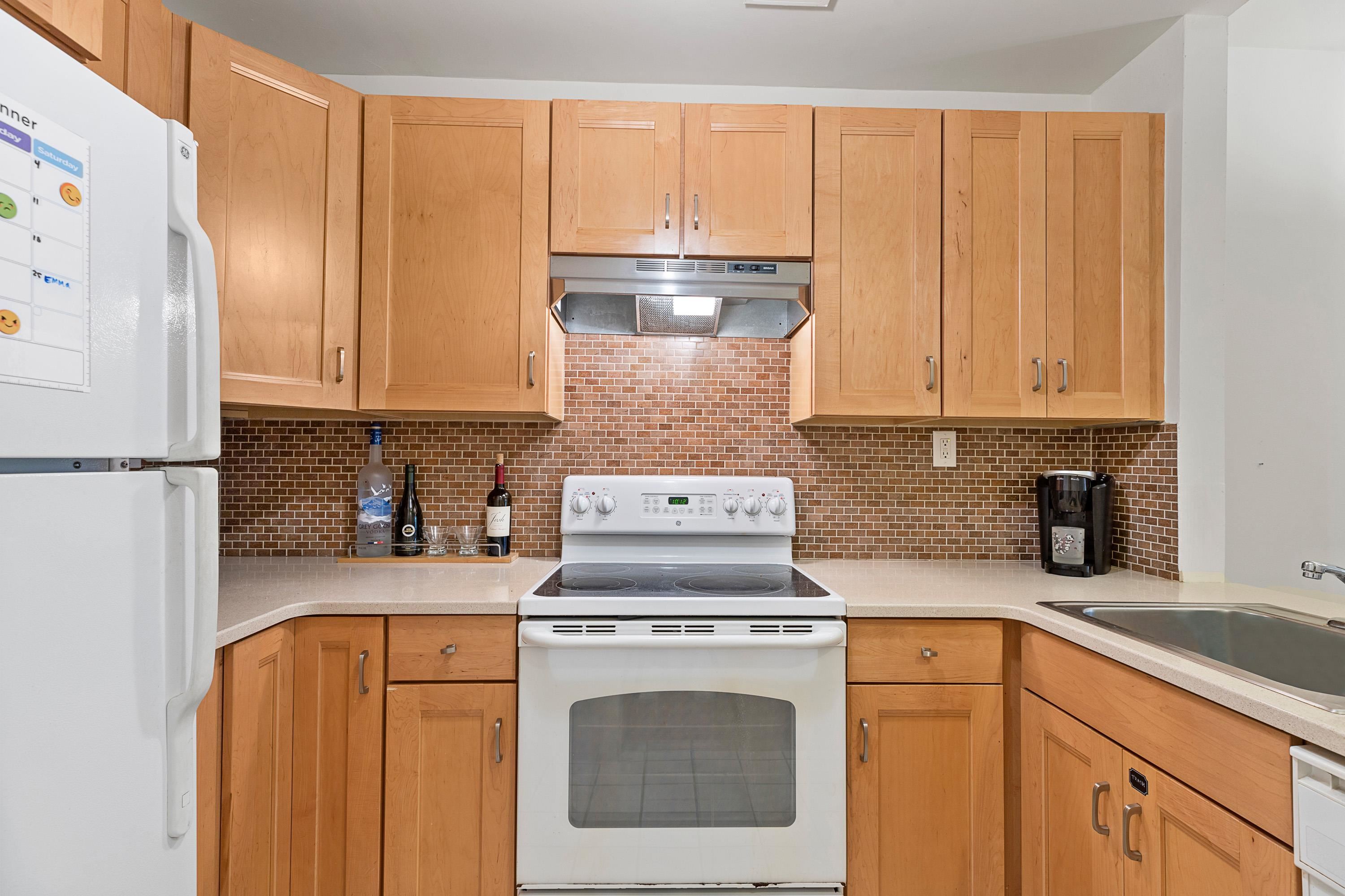 73 Madison Street, Unit 1N Hoboken, NJ 07030 - Photo 12 of 17 a kitchen with granite countertop a sink a stove and cabinets