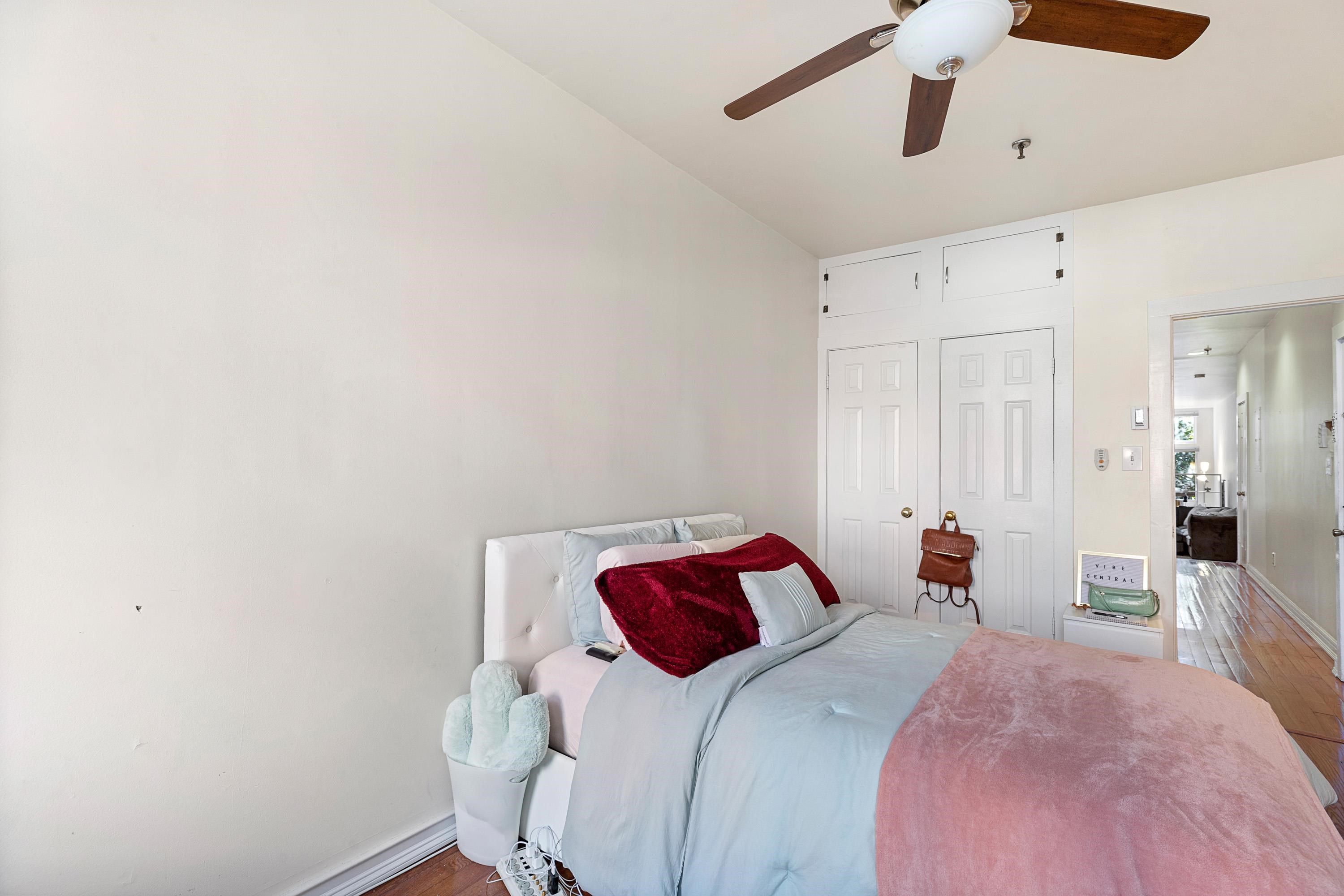 73 Madison Street, Unit 1N Hoboken, NJ 07030 - Photo 14 of 17 a bedroom with a bed and a chandelier