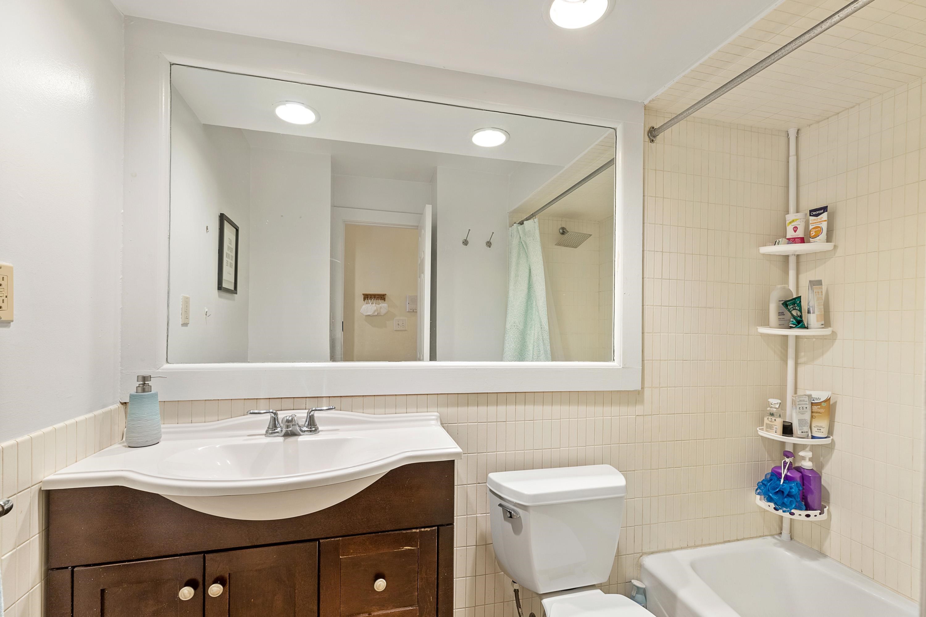 73 Madison Street, Unit 1N Hoboken, NJ 07030 - Photo 15 of 17 a bathroom with a sink toilet vanity and shower