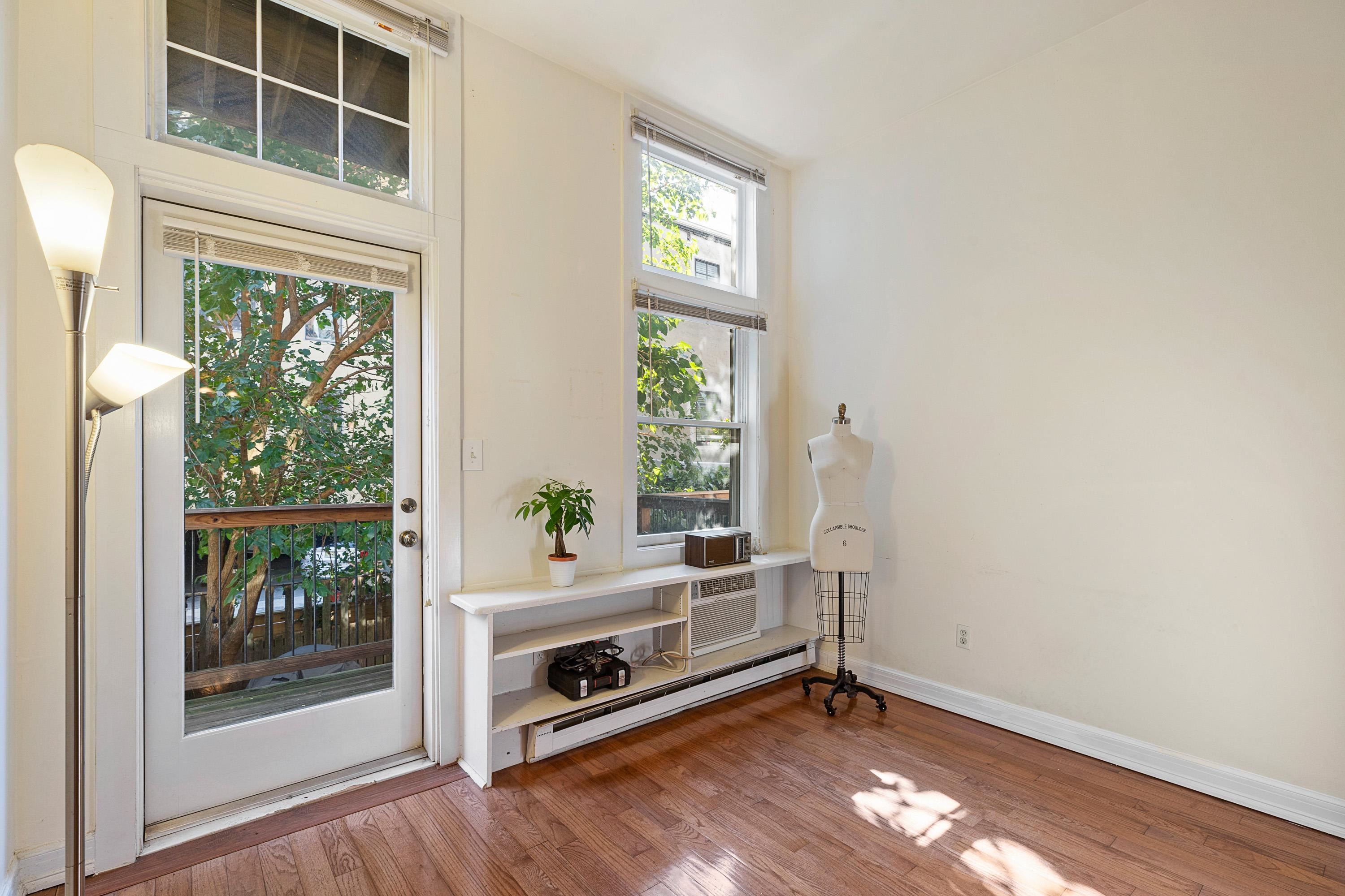 73 Madison Street, Unit 1N Hoboken, NJ 07030 - Photo 5 of 17 a view of an empty room with a window and wooden floor