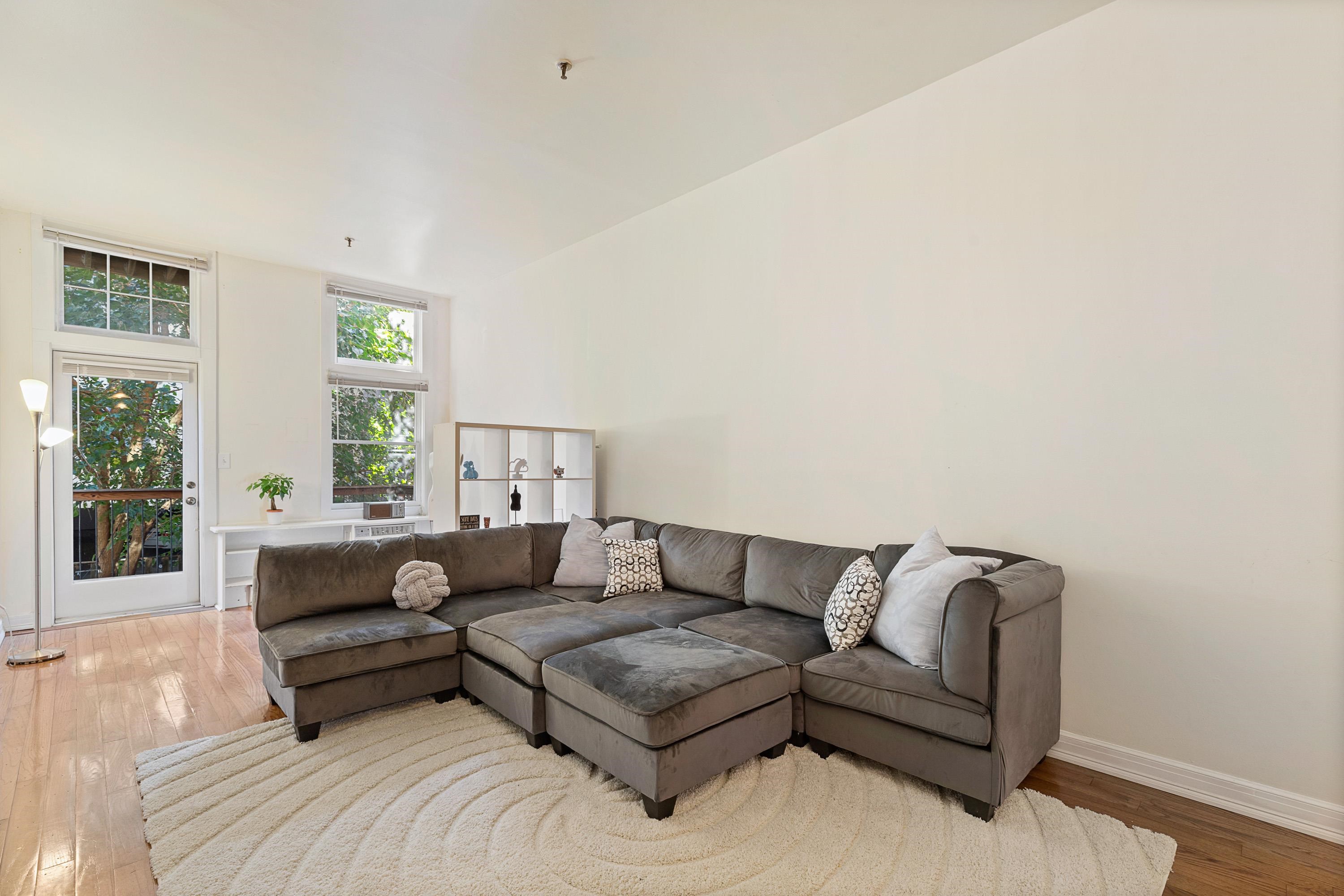 73 Madison Street, Unit 1N Hoboken, NJ 07030 - Photo 6 of 17 a living room with a couch and a window