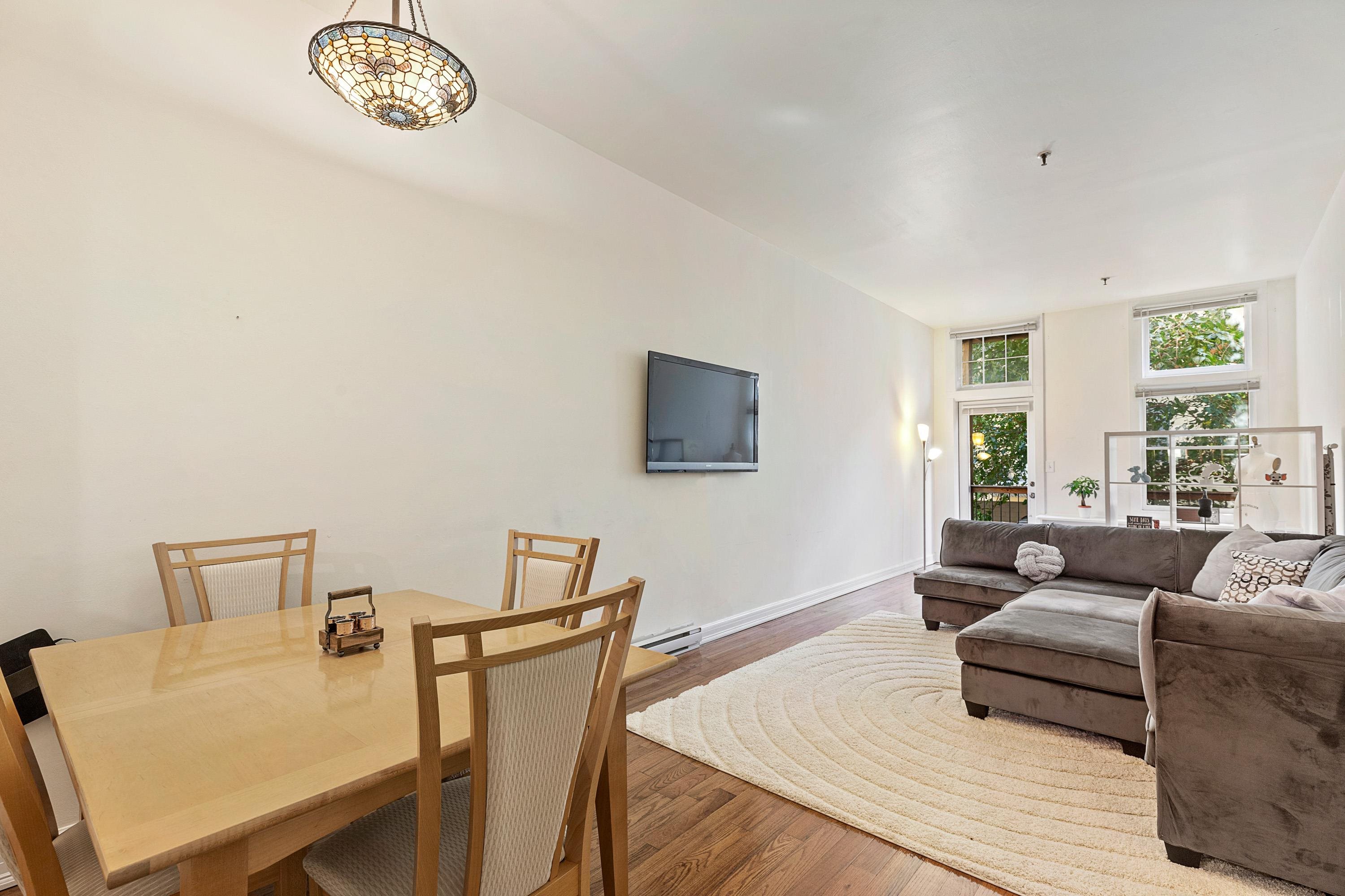 73 Madison Street, Unit 1N Hoboken, NJ 07030 - Photo 7 of 17 a living room with furniture a couch and a flat screen tv