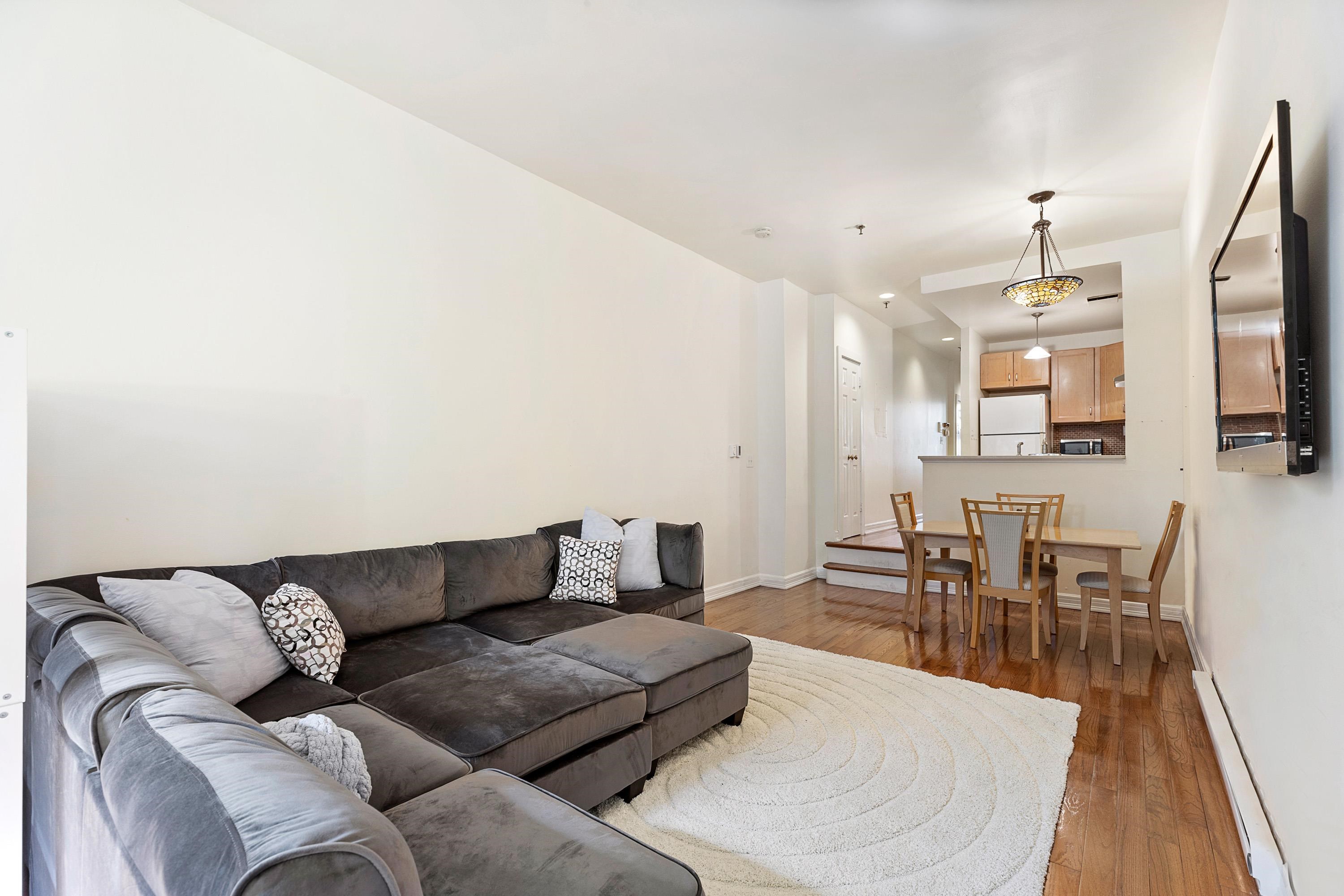 73 Madison Street, Unit 1N Hoboken, NJ 07030 - Photo 9 of 17 a living room with furniture a dining table and chairs with wooden floor