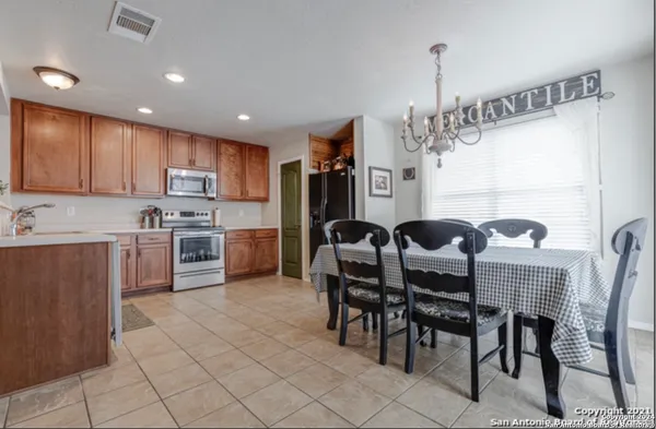 a kitchen with granite countertop cabinets a table and chairs in it