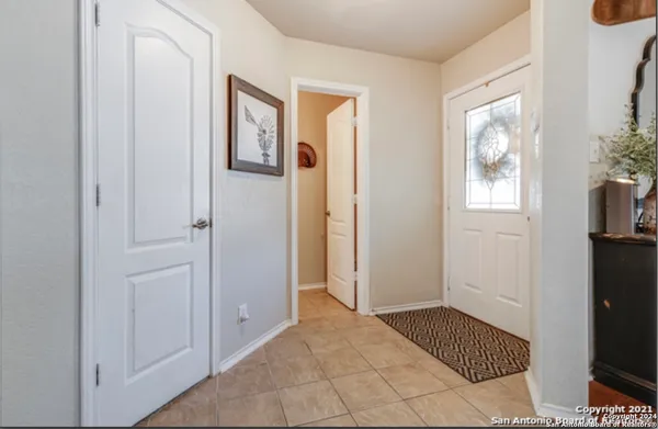 a view of an entryway with wooden floor and windows