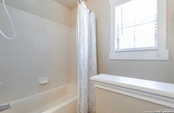 a bathroom with a bathtub and a shower