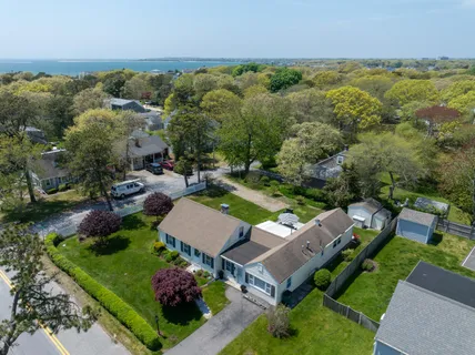 an aerial view of a house with garden space and street view