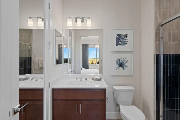 a bathroom with a toilet a sink and mirror