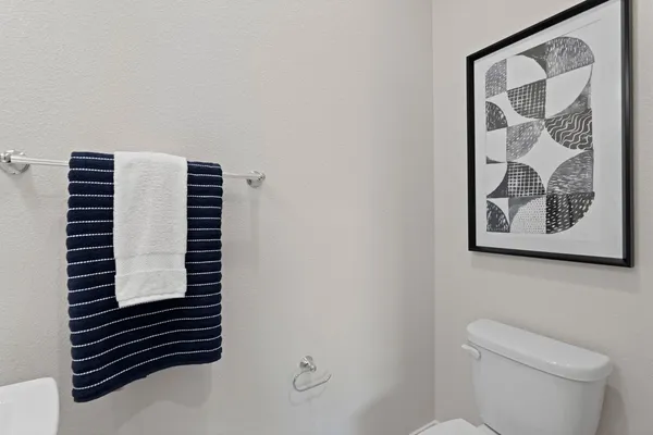 a view of bathroom with a toilet and a shower curtain