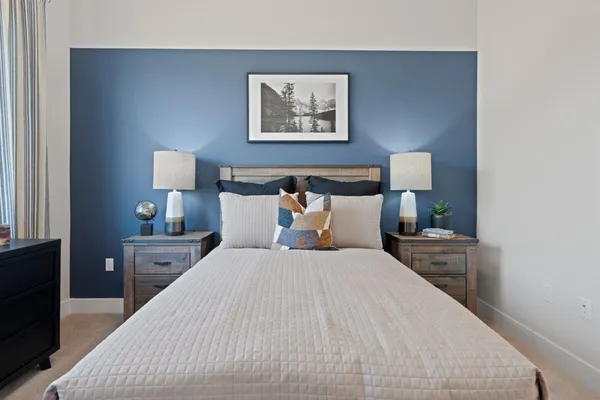 a bedroom with bed and night stand