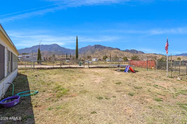 a view of swimming pool with a yard and mountain view