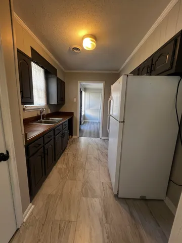 a kitchen with a refrigerator a stove top oven a sink and dishwasher