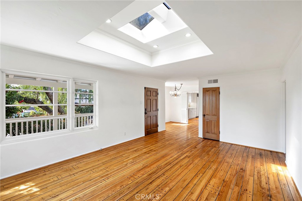 508 Seaview Street Laguna Beach, CA 92651 - Photo 7 of 28 a view of an empty room with wooden floor and a window
