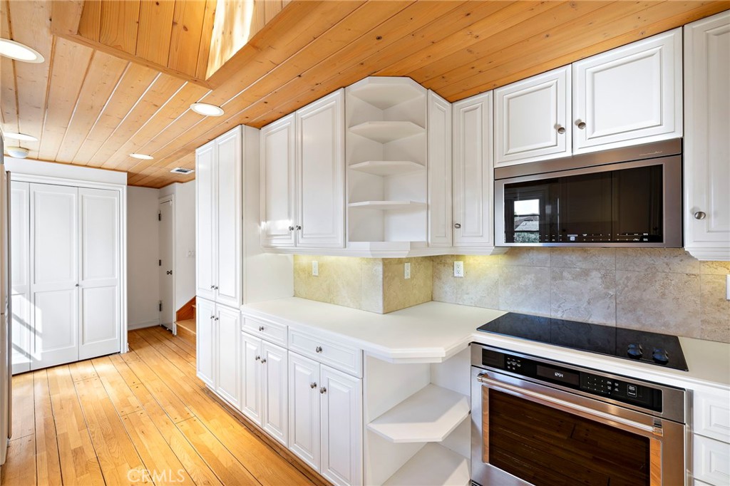 508 Seaview Street Laguna Beach, CA 92651 - Photo 8 of 28 a kitchen with granite countertop a stove fireplace and cabinets