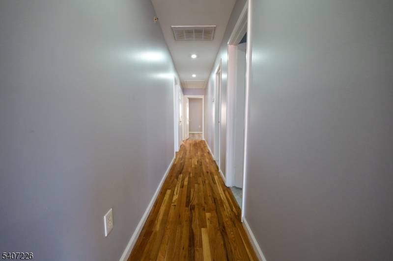 40 11th Avenue West, Unit 2 Newark, NJ 07107 - Photo 14 of 15 a view of a hallway with a lamp