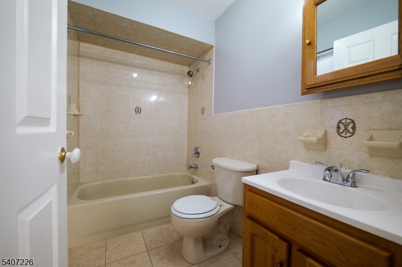 40 11th Avenue West, Unit 2 Newark, NJ 07107 - Photo 5 of 15 a bathroom with a sink a toilet and shower