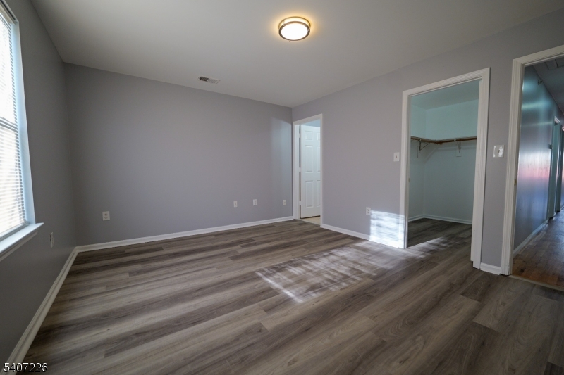40 11th Avenue West, Unit 2 Newark, NJ 07107 - Photo 7 of 15 a view of an empty room and window and wooden floor