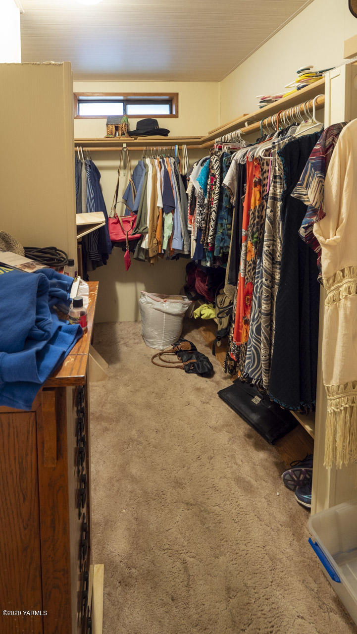 831 Swan Road Sunnyside, WA 98944 - Photo 2 of 19 a view of walk in closet with clothes
