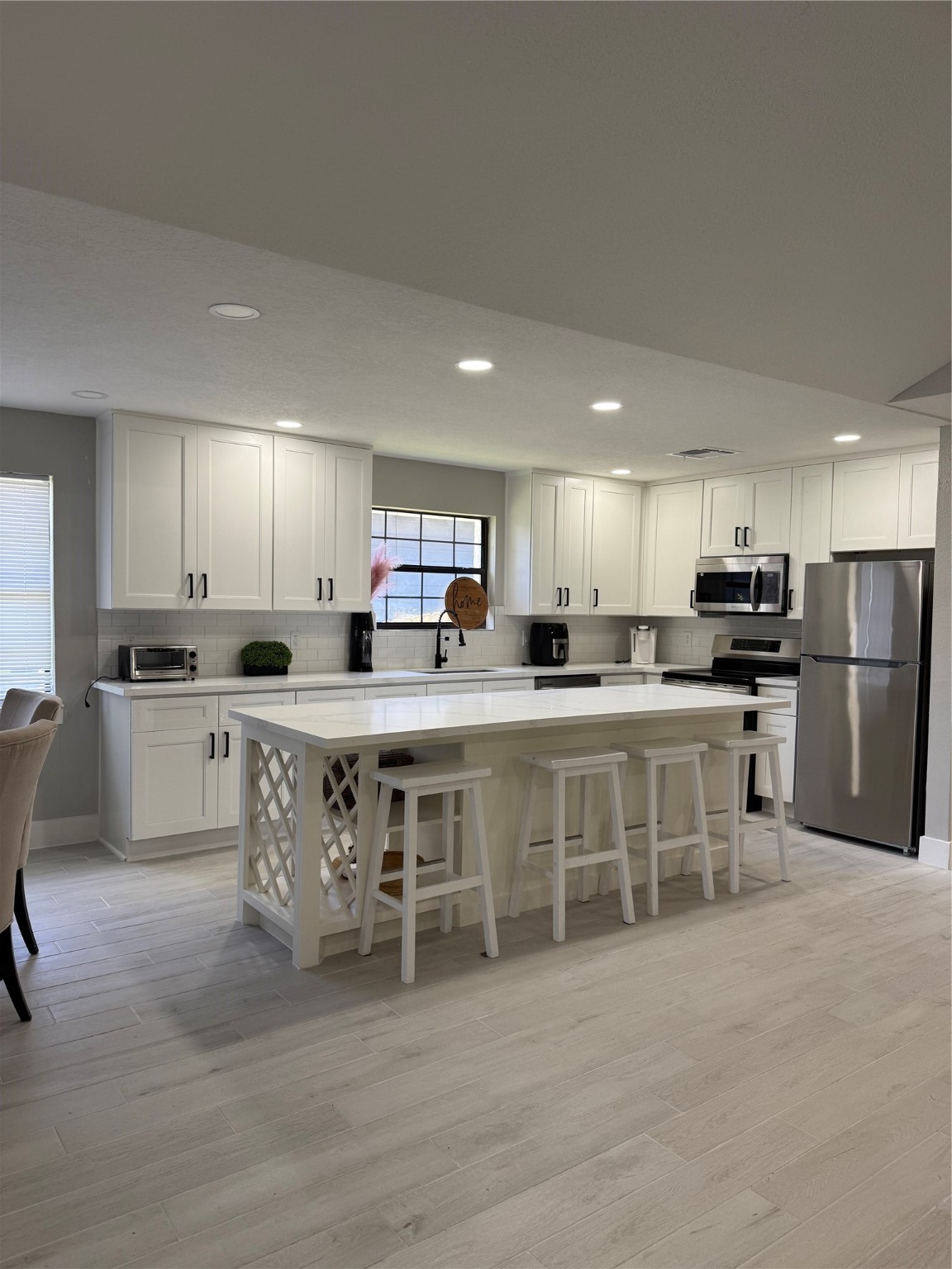 175 Heather Lane Livingston, TX 77351 - Photo 3 of 12 a kitchen with white cabinets and stainless steel appliances