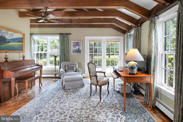a living room with patio furniture and a chandelier