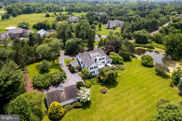 an aerial view of residential house with swimming pool and outdoor space