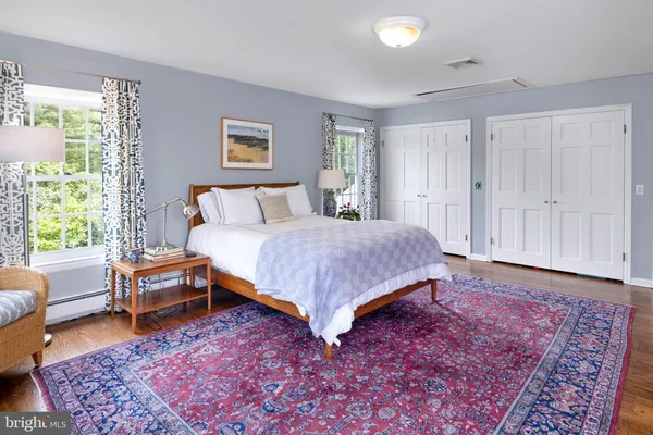 a spacious bedroom with a bed and a couch