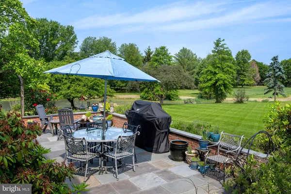 a view of a patio with table and chairs under an umbrella