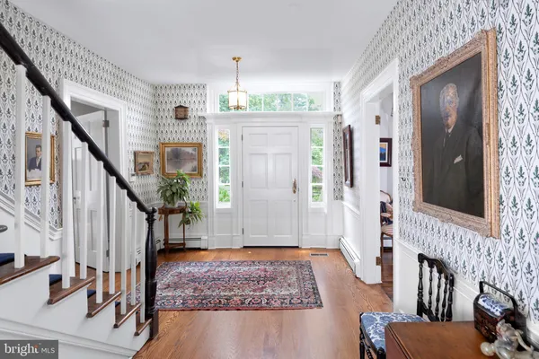 a view of entryway with wooden floor and stairs