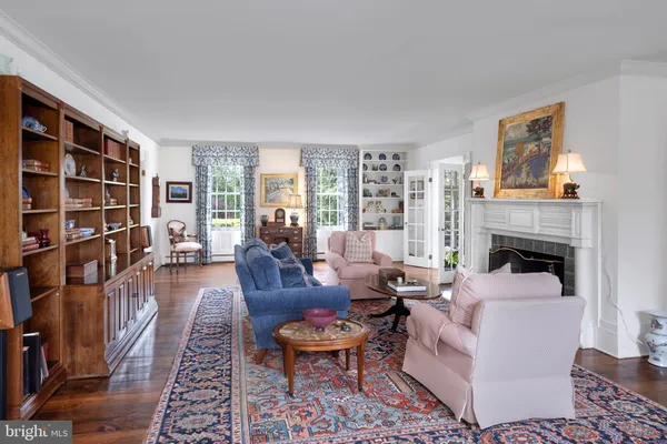 a living room with furniture a rug and a fireplace