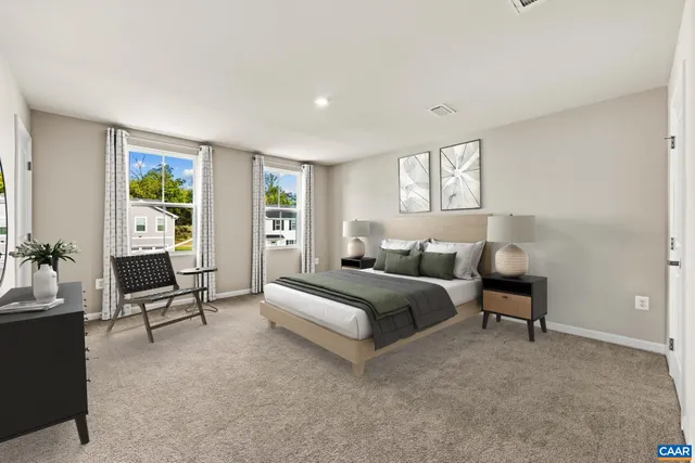 a spacious bedroom with a bed and a couch