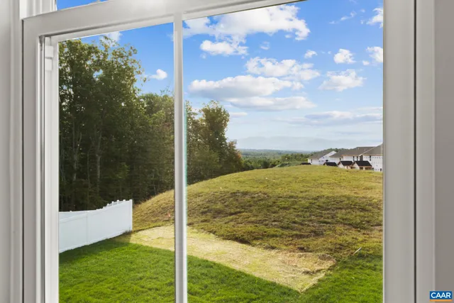 a front view of a house with a garden and plants