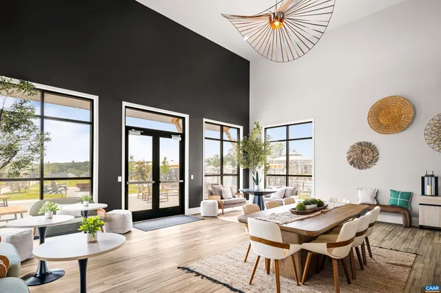 a kitchen with stainless steel appliances a microwave a stove a sink dishwasher and a refrigerator with wooden floor