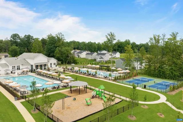 an aerial view of a house with swimming pool garden and outdoor seating