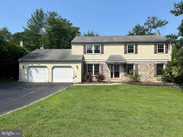 a front view of a house with swimming pool having outdoor seating
