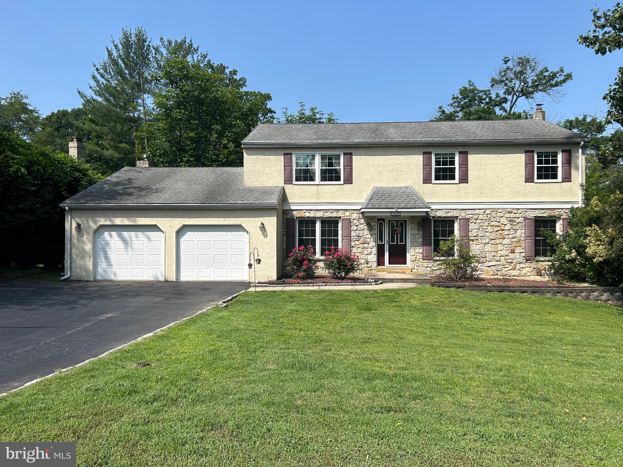 a front view of a house with swimming pool having outdoor seating