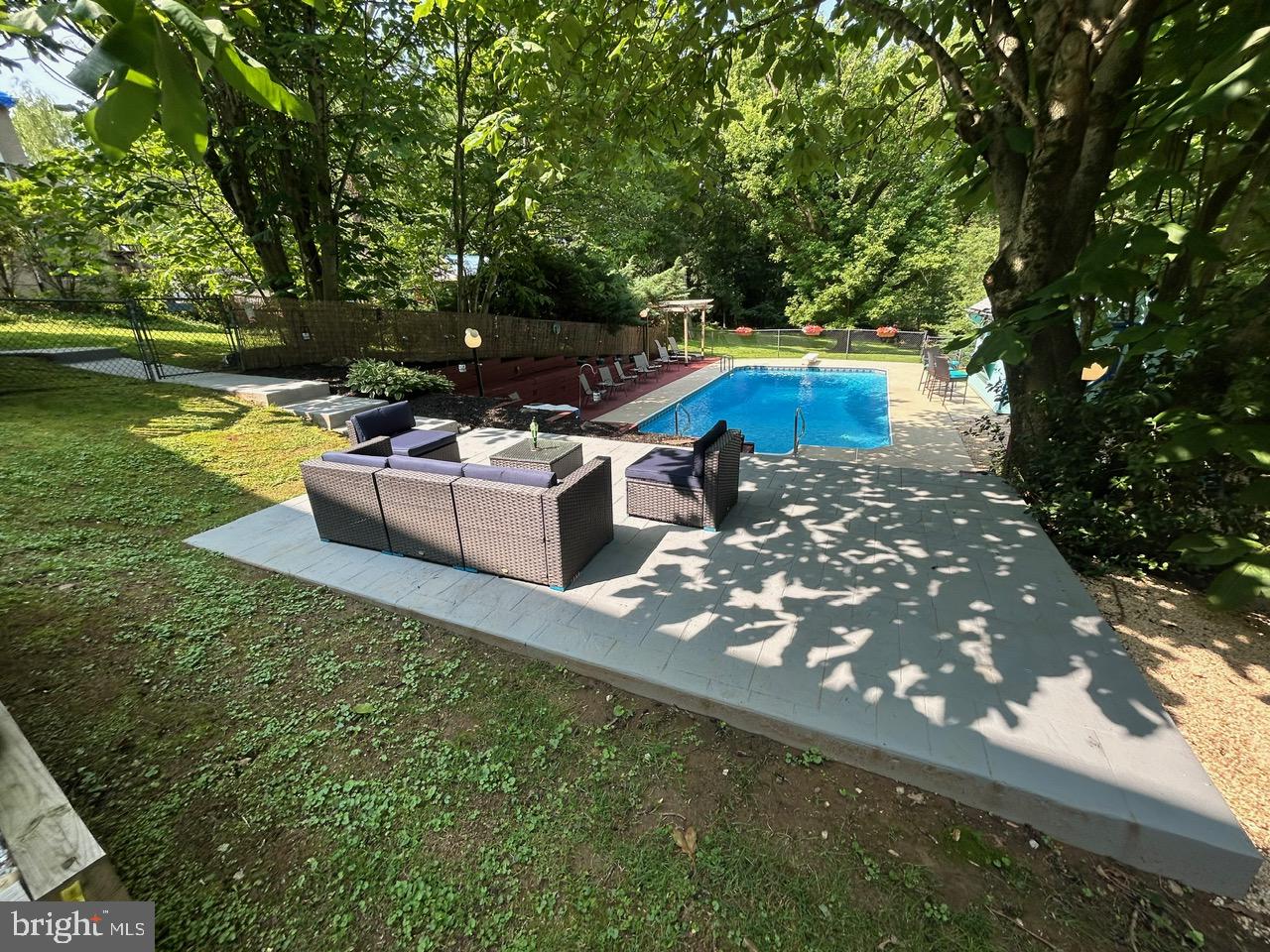 1008 Lincoln Avenue Springfield, PA 19064 - Photo 13 of 53 a view of a patio with table and chairs potted plants and a large tree