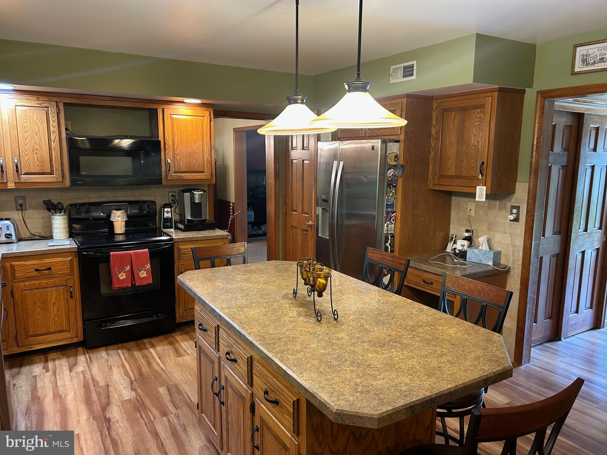 1008 Lincoln Avenue Springfield, PA 19064 - Photo 27 of 53 a kitchen with stainless steel appliances granite countertop a sink a stove and a refrigerator