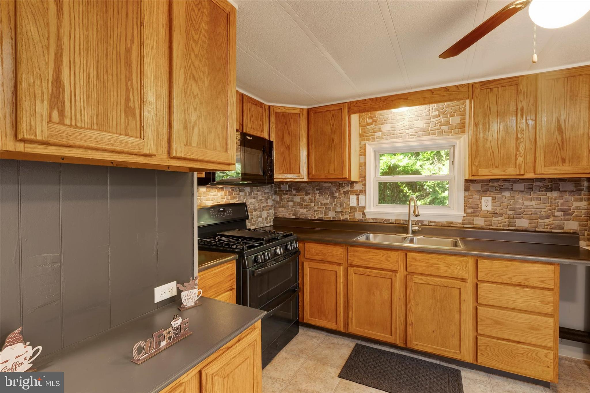2 Windsor Acres Windsor, PA 17366 - Photo 7 of 18 a kitchen with stainless steel appliances granite countertop a sink stove and cabinets