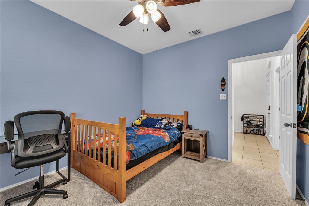 9453 Centennial Drive Waco, TX 76708 - Photo 7 of 37 a bedroom with furniture and a ceiling fan