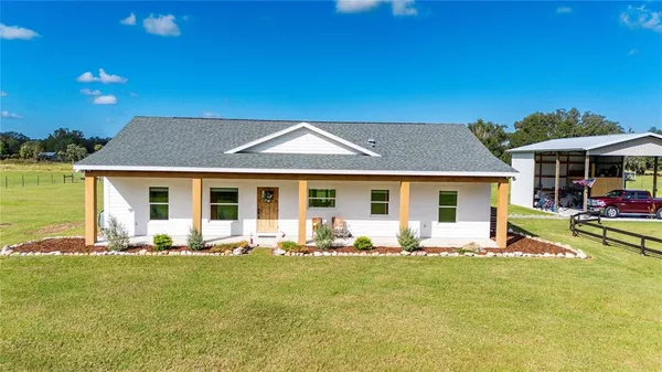 a living room with furniture fireplace and flat screen tv